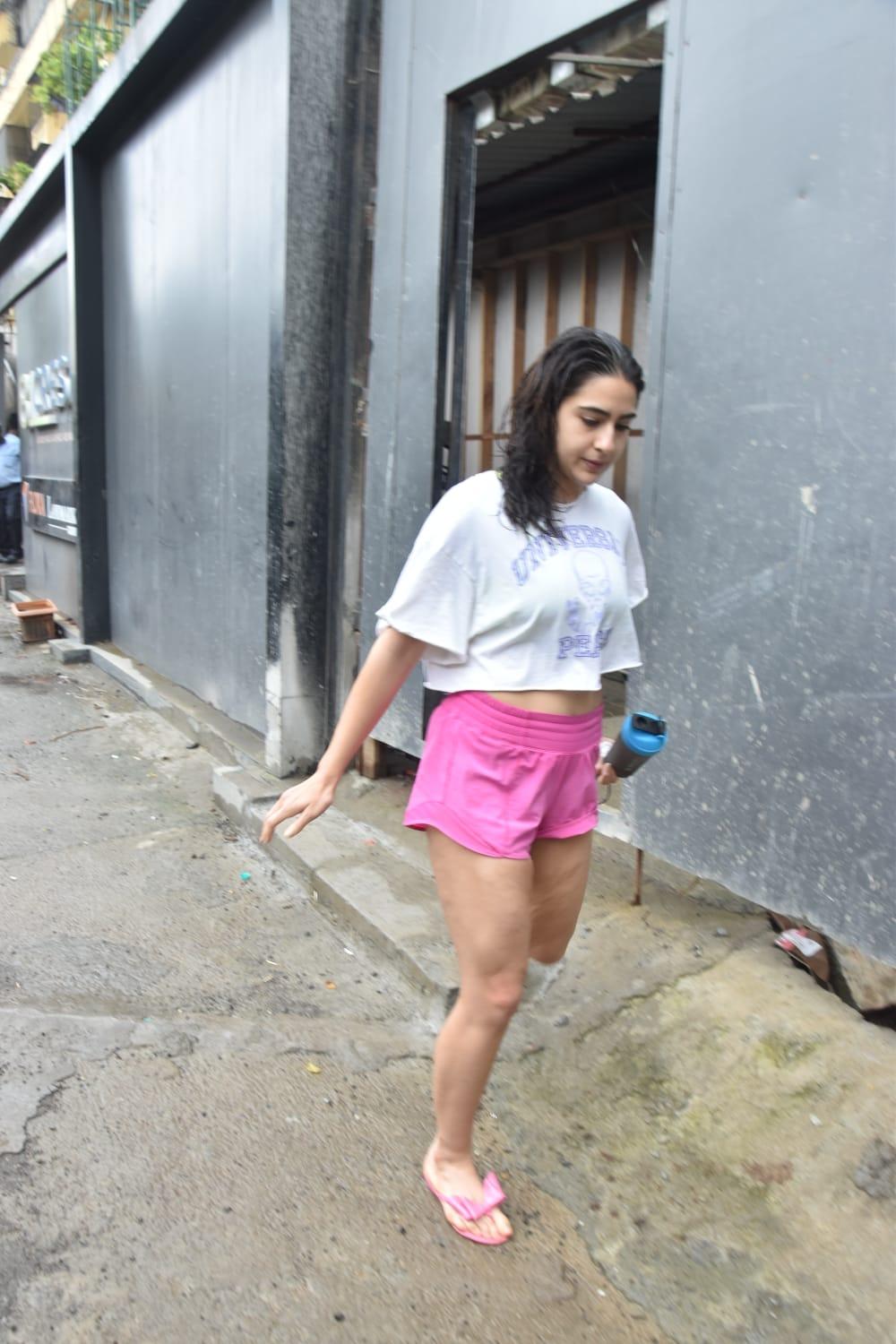 Sara looked as cute as can be in a white tee and cute pink shorts